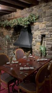 a long wooden table with chairs and aendant light at The Old Manor House Hotel in Keynsham