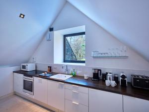 a white kitchen with a sink and a window at 3 Bed in Perth PE577 in Perth