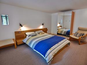 a bedroom with a large bed and a mirror at 3 Bed in Perth PE577 in Perth