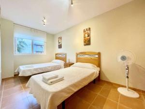 a hospital room with two beds and a fan at Apartamento con vistas al mar piscina padel in Barrio-Mar