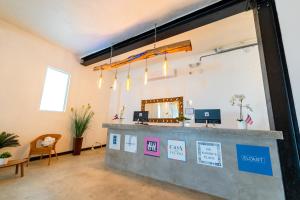 a lobby with a reception desk and a mirror at Lofts At San Agustin in San Juan