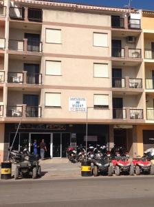 a group of motorcycles parked in front of a building at Apartamentos Vicent in Peniscola