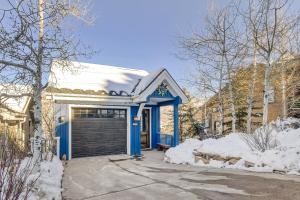 a blue house with a garage in the snow at Murdock by AvantStay Cozy Townhouse w Hot Tub Walk To Park City Mountain in Park City