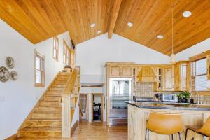 a kitchen with wooden cabinets and a staircase in a house at Murdock by AvantStay Cozy Townhouse w Hot Tub Walk To Park City Mountain in Park City