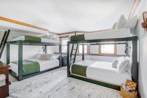 two bunk beds in a room with white walls at Murdock by AvantStay Cozy Townhouse w Hot Tub Walk To Park City Mountain in Park City