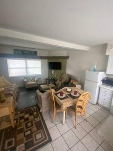 a kitchen and living room with a table and chairs at Private Large Studio 19-Directly Across from Beach in St. Pete Beach