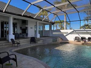 a swimming pool in the backyard of a house at Tropical Pool Paradise - Minutes from the Beach Venice in Nokomis