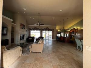 a large living room with couches and a fireplace at Tropical Pool Paradise - Minutes from the Beach Venice in Nokomis