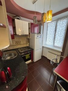 a kitchen with a sink and a stove top oven at Квартира в центре города Тирасполь! Тихий и удобный район! in Tiraspol