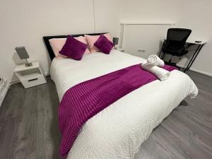 a bedroom with a large bed with purple pillows at Super double bedroom zone 1 in London