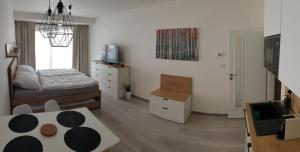 a living room with two beds and a table at Apartment KORZO 318/3 in Lipno nad Vltavou