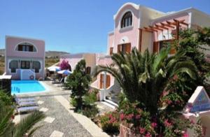 a house with a swimming pool in front of it at Villa Georgia in Perissa