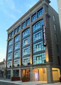 a large building with many windows on a street at The Laundry Rooms Augusta in Hamilton