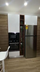a kitchen with a stainless steel refrigerator and an oven at Luxury 3-bedroom apartment in Accra