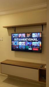 a flat screen tv hanging on a wall at Luxury 3-bedroom apartment in Accra +20 photos
