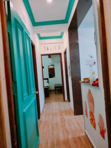 a hallway with a room with a blue ceiling at Ronne's 2Bhk vacation rental near Baga Beach in Calangute