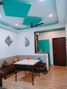 a living room with a couch and a table at Ronne's 2Bhk vacation rental near Baga Beach in Calangute
