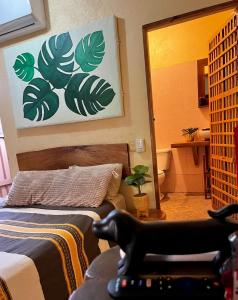 a room with a bedroom with a bed and a mirror at Desactivado in Puerto Escondido