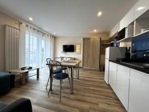 a kitchen and living room with a table and chairs at SIEDEM WYDM in Rowy
