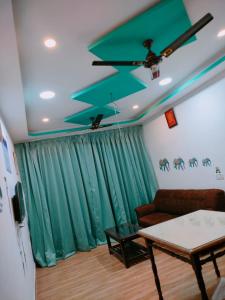 a living room with a couch and a table at Ronne's 2Bhk Apartment near Baga Beach in Calangute