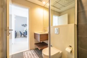 a bathroom with a shower and a toilet and a sink at Al Meydan - Prime Views 1BR in Al Meydan in Dubai