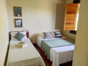 A bed or beds in a room at Casa Candeia