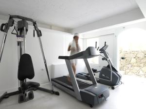 a man running on a treadmill in a gym at Semeli Hotel Mykonos in Mikonos