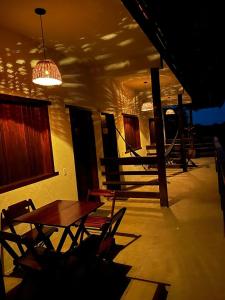 a room with a table and chairs in a building at Pousada Veleiro Itaúnas in Itaúnas +9 photos
