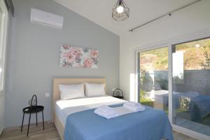 a bedroom with a bed with towels on it at Eleonas View Suites in Nea Peramos +52 photos