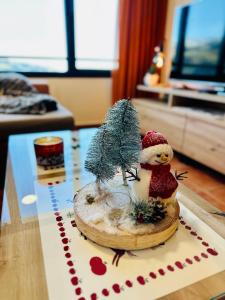 a figurine of a snowman on a glass table at Monte Oiz con wifi y parking gratis in Sierra Nevada