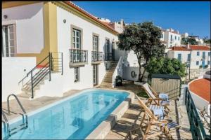 a swimming pool in front of a house at Casa Condessa by LovelyStay in Azenhas do Mar