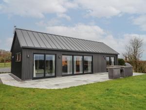 a black house with a large group of windows at Skylark in Huggate