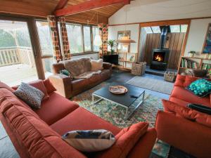 a living room with red couches and a fireplace at The Danish House in Montgomery