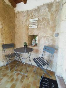 einen Tisch und zwei Stühle in einem Zimmer in der Unterkunft Chambre d'hôte Lavande - Le soleil des Cévennes in Saint-Jean-du-Gard
