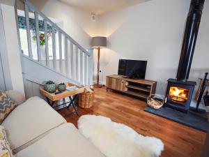 a living room with a couch and a wood stove at 1 bed in Chepstow 76606 in Wolves Newton