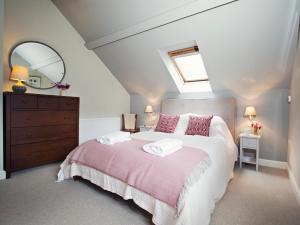 a bedroom with a large bed and a mirror at 1 bed in Chepstow 76606 in Wolves Newton