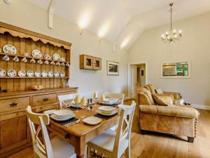 una sala da pranzo con tavolo e divano di 2 bed property in Wareham 83814 a Morden