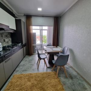 a kitchen with a table and chairs in a room at Apartments in the center in Chişinău
