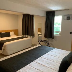 Säng eller sängar i ett rum på Hotel Emperador centro Guadalajara y Remodelado