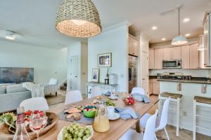 a kitchen and dining room with a table with food on it at Coral By AvantStay Gorgeous Three Story Home w Two Balconies in Destin