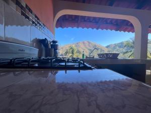 a kitchen counter with a view of a mountain at Casa Berita in Yelapa