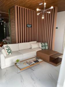 a living room with a white couch and a table at hihome - Independência 915 in Juiz de Fora