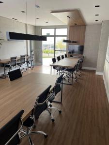 a conference room with tables and chairs in a building at hihome - Independência 915 in Juiz de Fora +56 photos