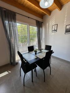 a dining room with a table and chairs and a window at Increíble departamento a estrenar en Mendoza in Godoy Cruz