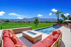 une terrasse avec un canapé et une piscine dans l'établissement Legends by AvantStay Stunning Golf Villa Featuring Spa Pool Fire-Pit, à La Quinta