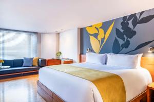 A bed or beds in a room at Avani Royal Zona T Bogotá Hotel (previously NH Bogotá Boheme Royal)