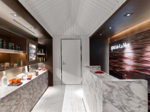 a lobby of a hotel with a white reception counter at Baccarat Hotel and Residences New York in New York