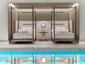 a bedroom with two beds and a swimming pool at Baccarat Hotel and Residences New York in New York