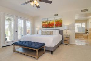 a bedroom with a large bed and a ceiling fan at Sonoran Sunshine by AvantStay Pool Putting Green BBQ Ping Pong Pool Table Entertainers Wonderland in Scottsdale