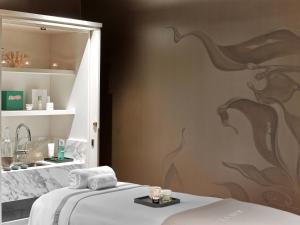 a bedroom with a bed and a sink in a room at Baccarat Hotel and Residences New York in New York